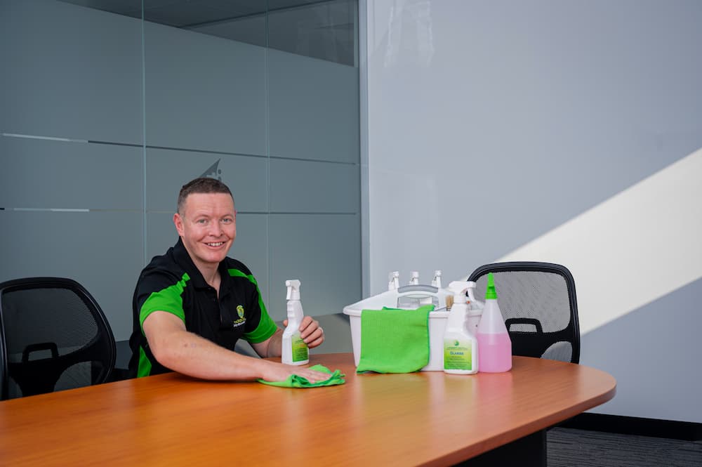 A Green Clean Team staff member wiping a table with eco-friendly products during a commercial cleaning service in Bendigo, Central Victoria.