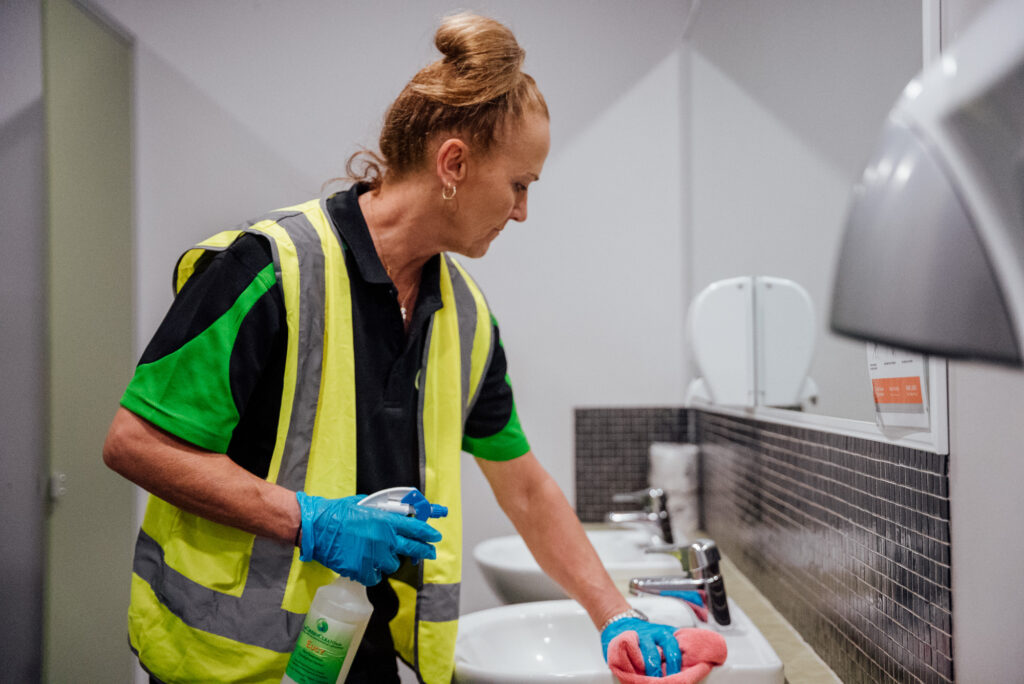 A Green Clean Team member cleaning a bathroom as part of a regular, commercial eco-friendly cleaning job in Central Victoria