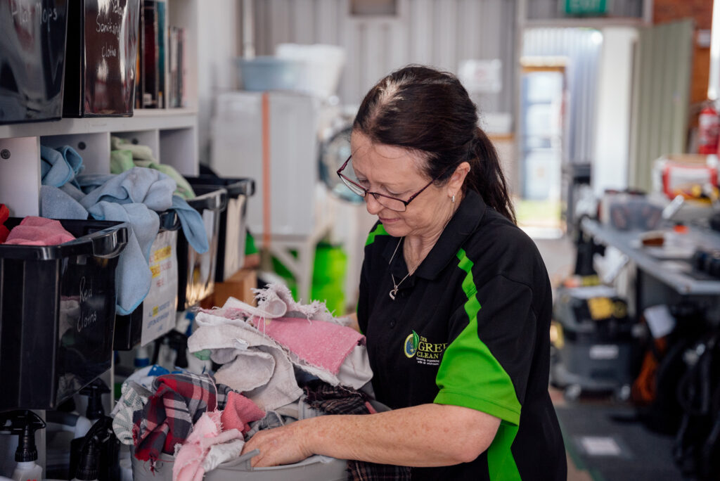 A Green Clean Team staff member sorting through eco-friendly cleaning cloths in a depot in Bendigo, Central Victoria