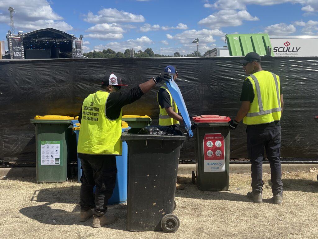 Green Clean Team staff sorting waste into recycling and general bins at an outdoor music event in Bendigo, Central Victoria, ensuring clean, sustainable event management.